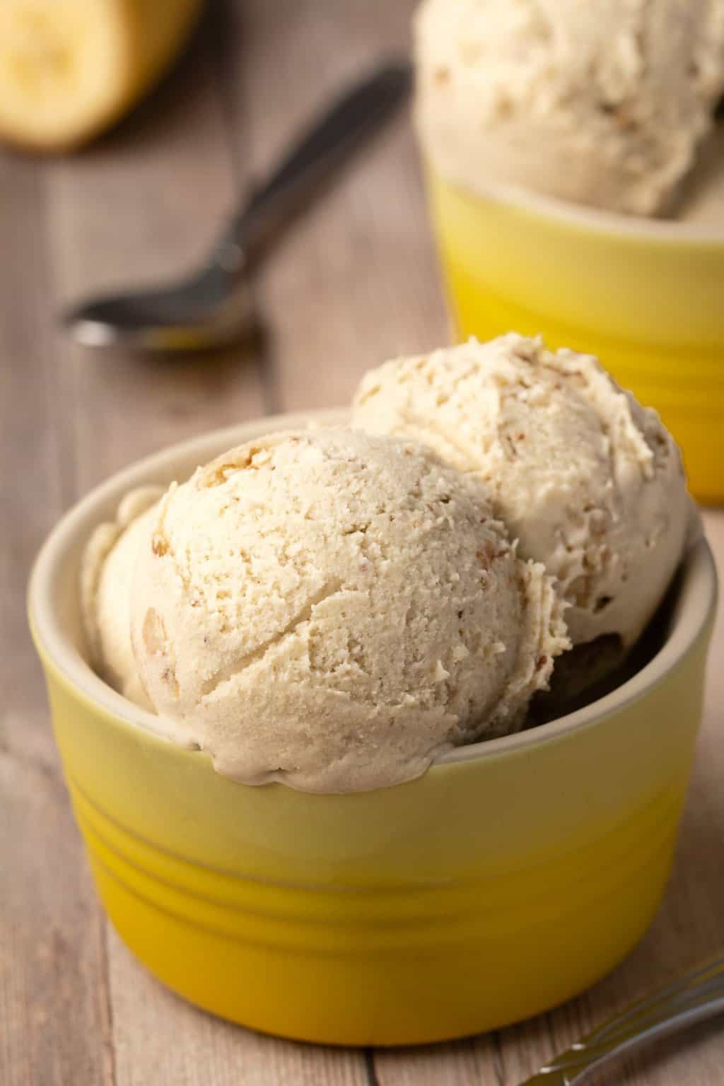 Scoops of vegan banana ice cream in a yellow bowl. 