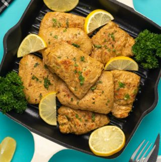 Vegan chicken with fresh lemon and parsley in a grill pan.