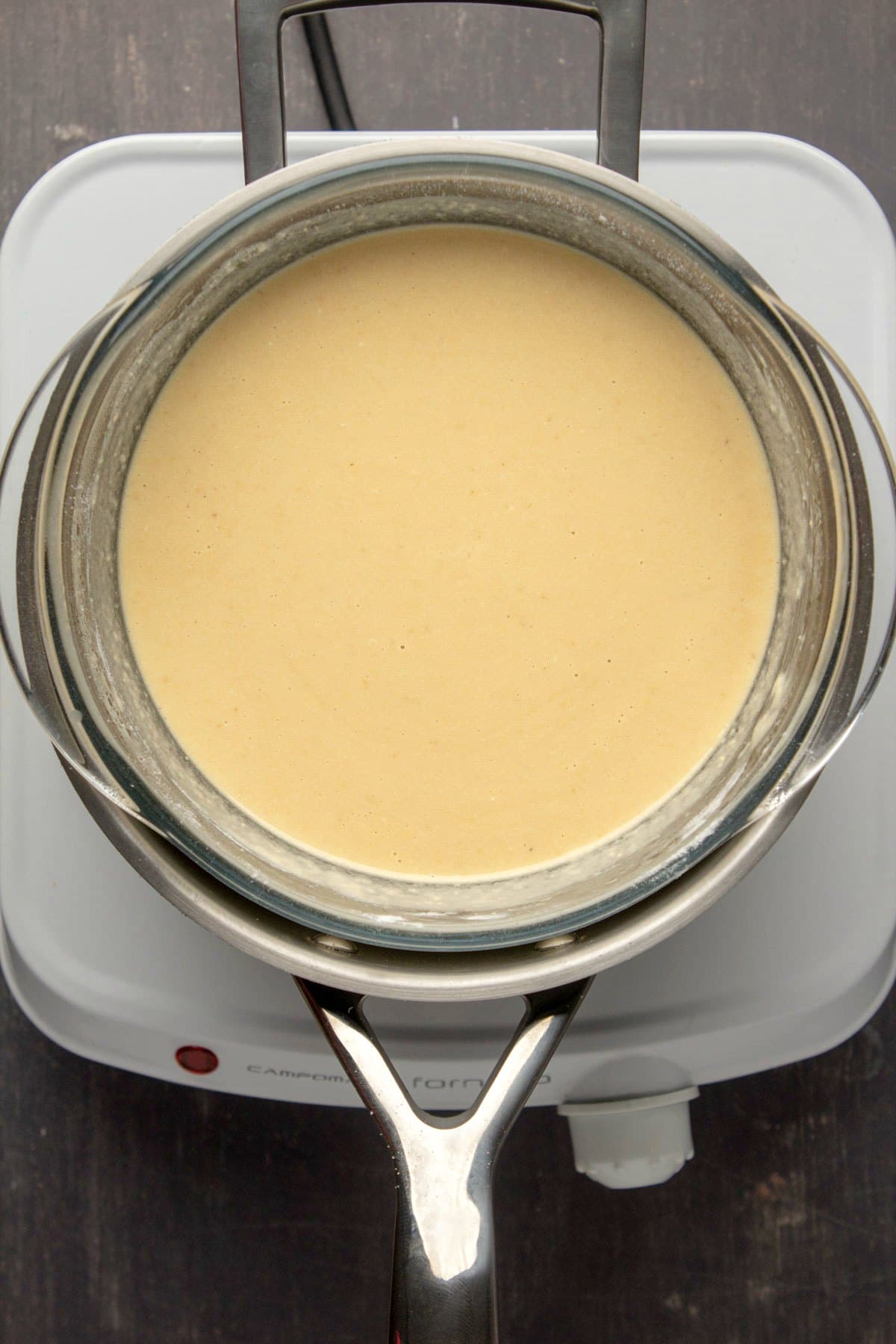 Vegan white chocolate mixture in a homemade double boiler.