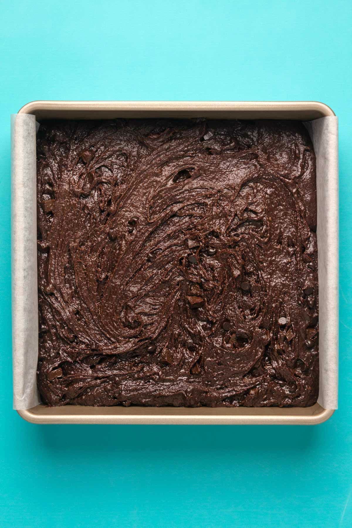 Brownie batter in a 9x9 square baking dish.