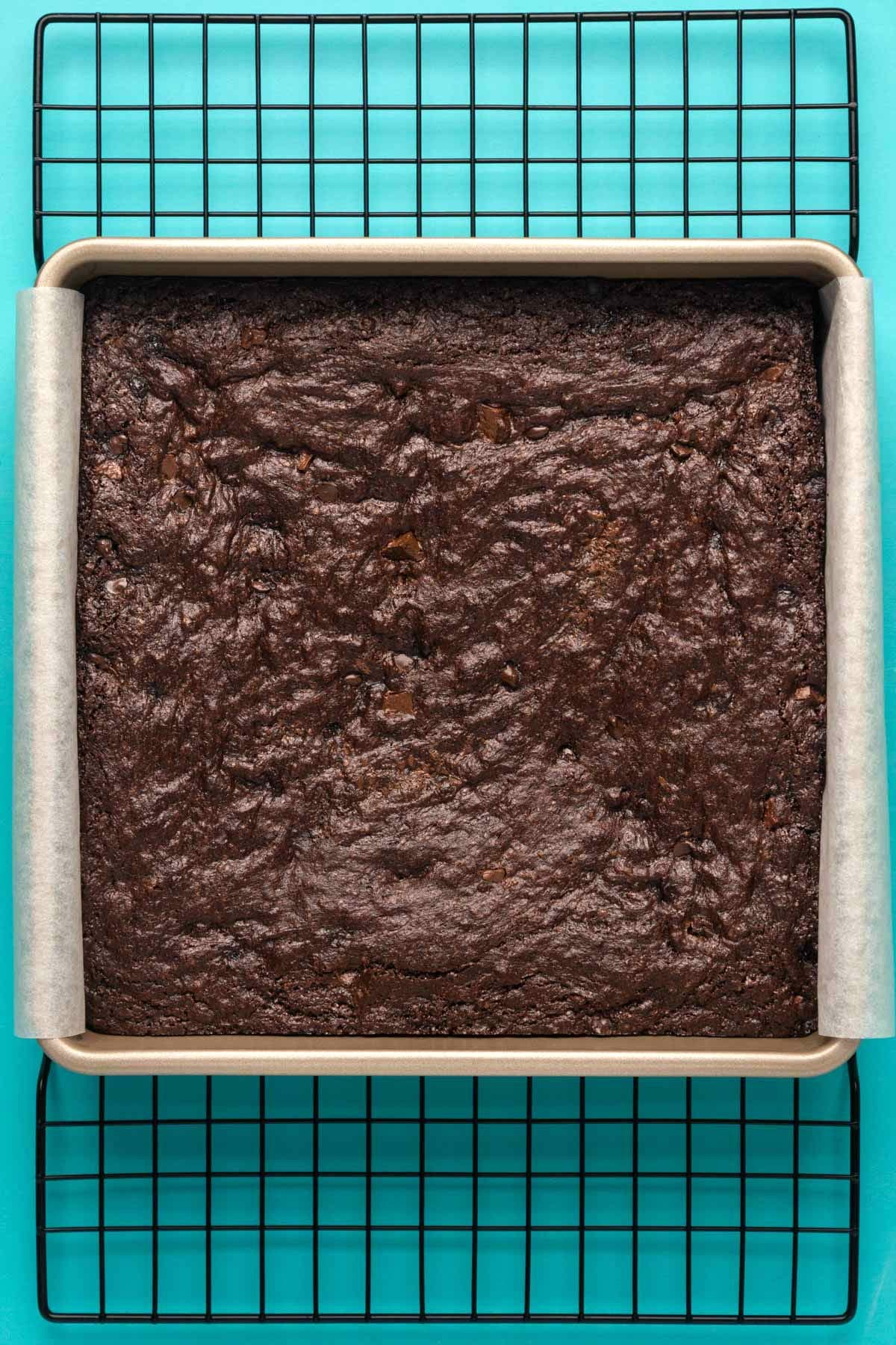 Freshly baked brownies in a square baking dish.