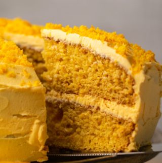 Sliced vegan orange cake on a cake stand.