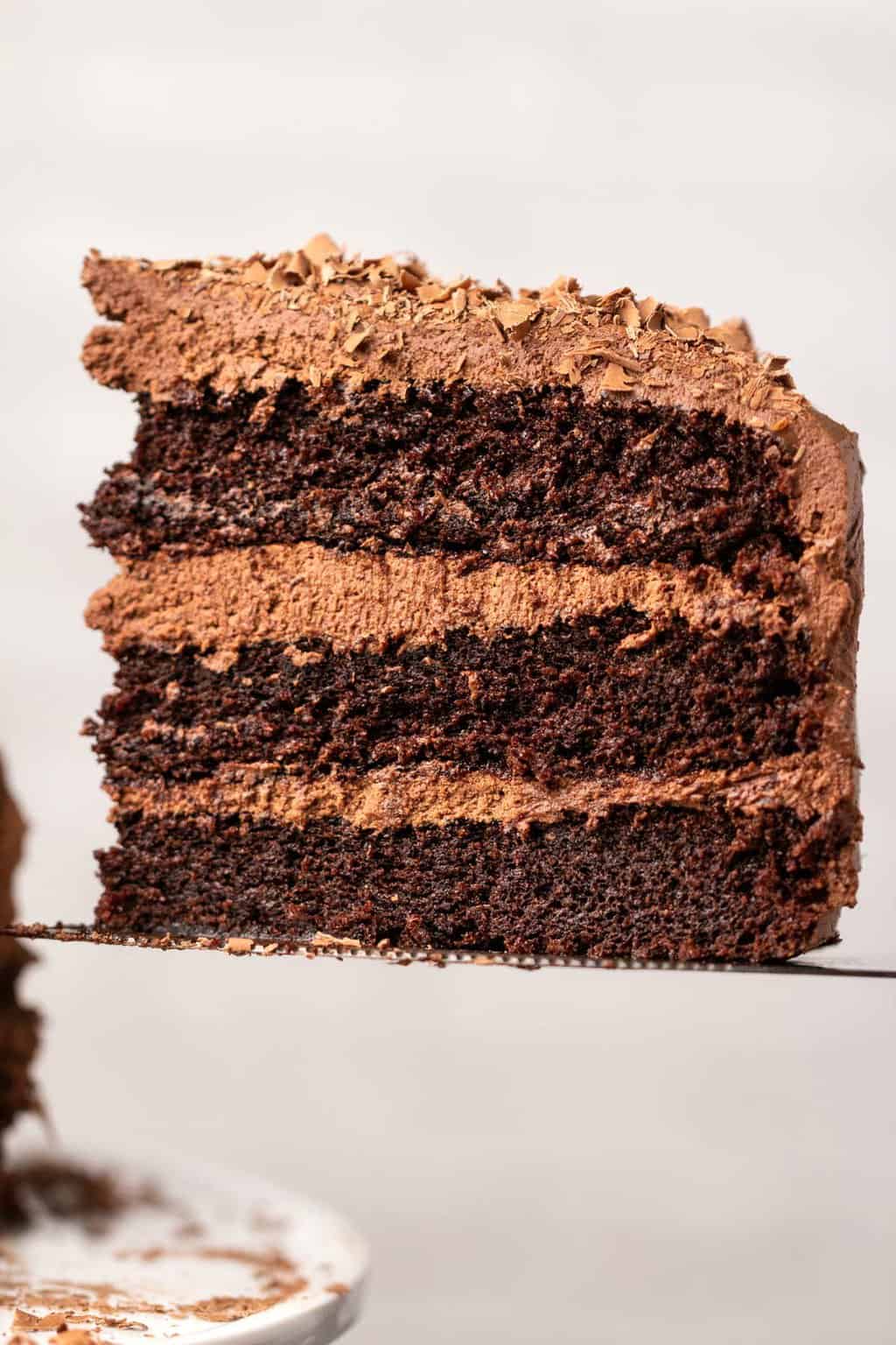 Slice of dairy free chocolate cake on a cake lifter. 