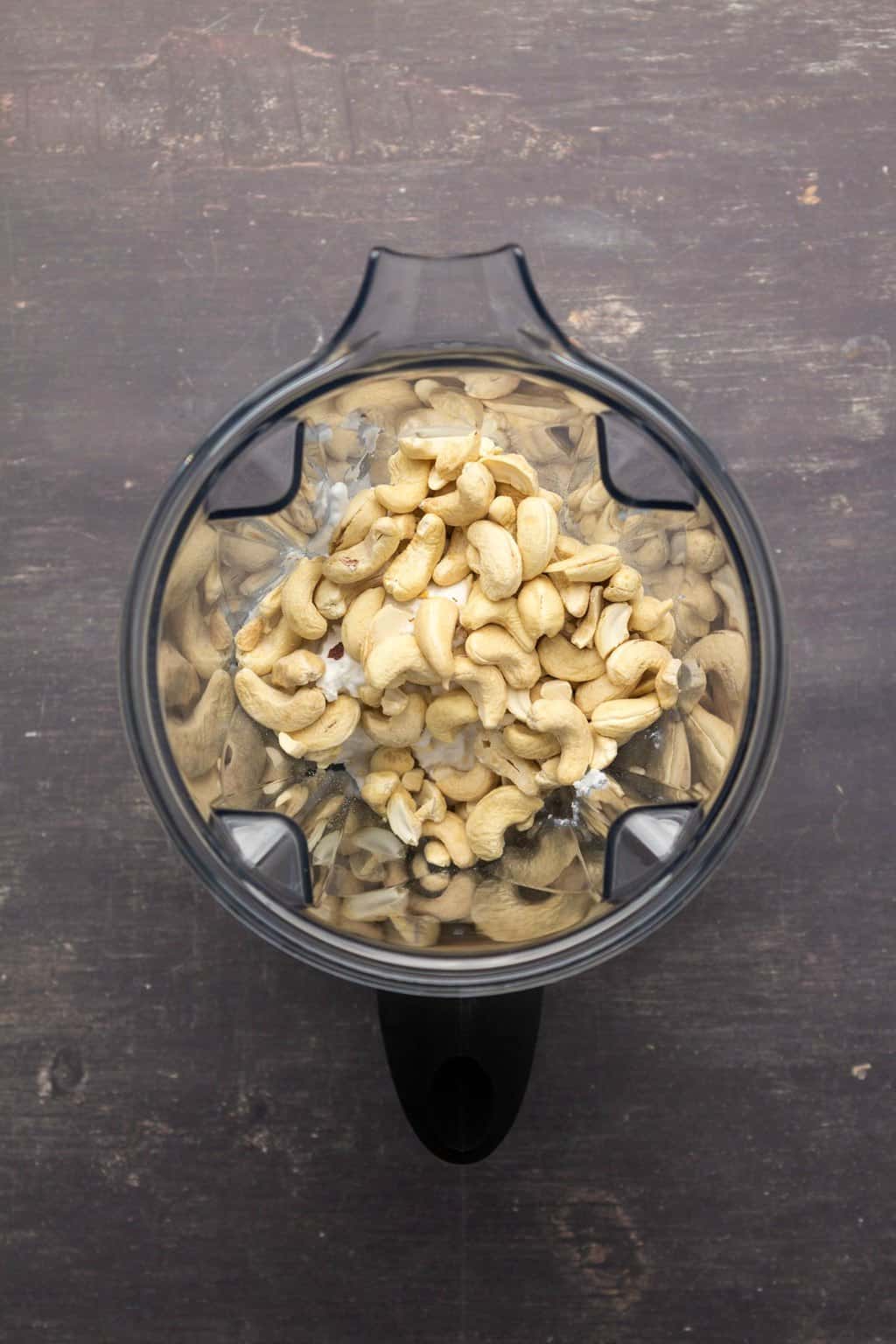 Cashews and coconut cream in a blender jug. 
