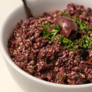 Olive tapenade in a white bowl.