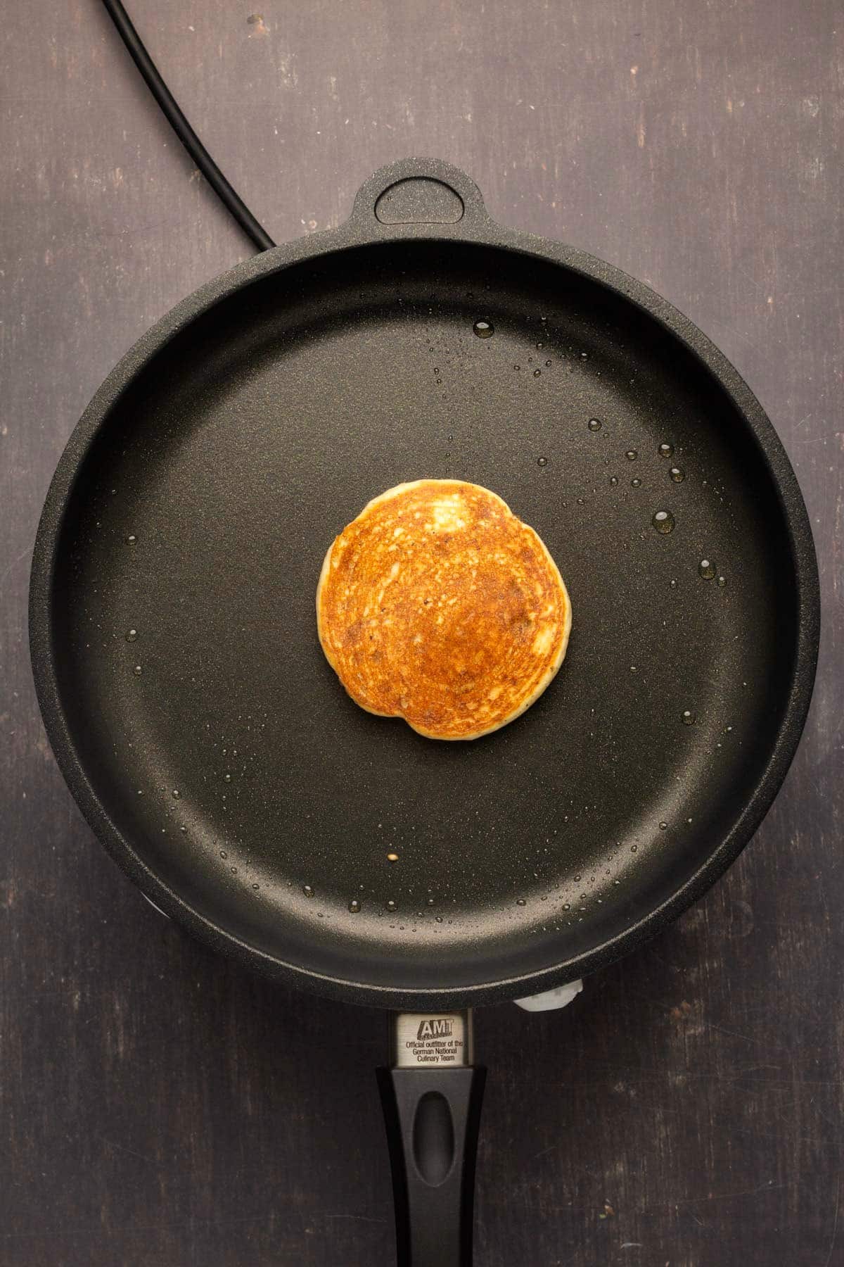 Flipped pancake in a frying pan.