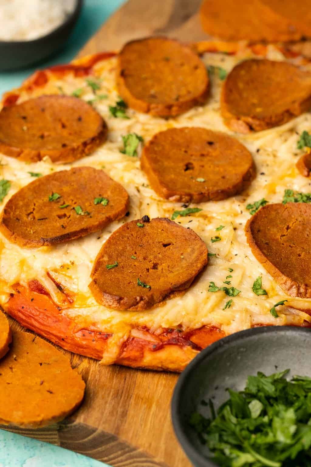 Vegan pepperoni slices on a vegan pizza. 