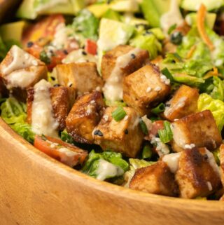 Tofu salad in a wooden bowl.
