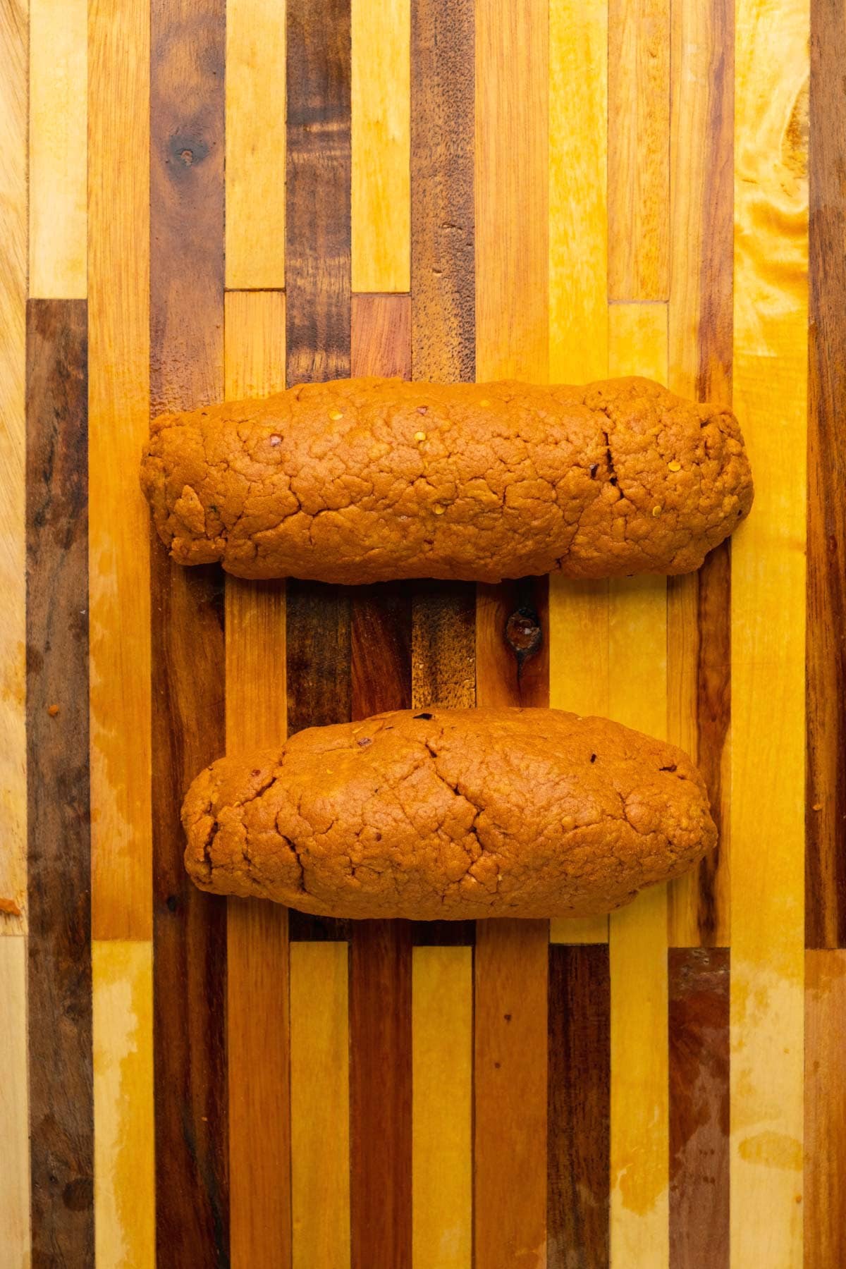 Seitan formed into two loaf shapes.