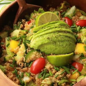 Vegan quinoa salad in a wooden salad bowl.