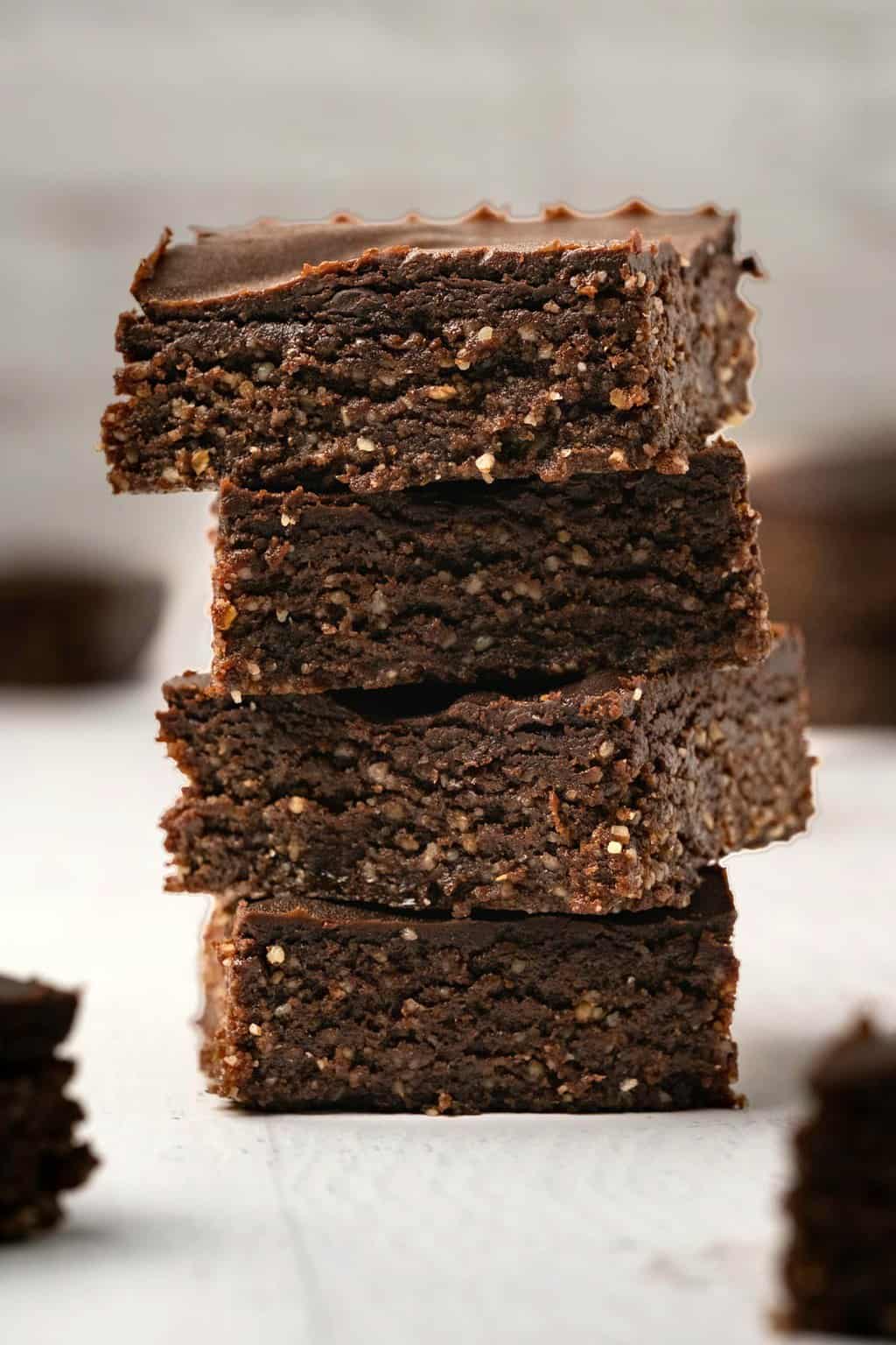 Raw vegan brownies stacked up on top of each other. 