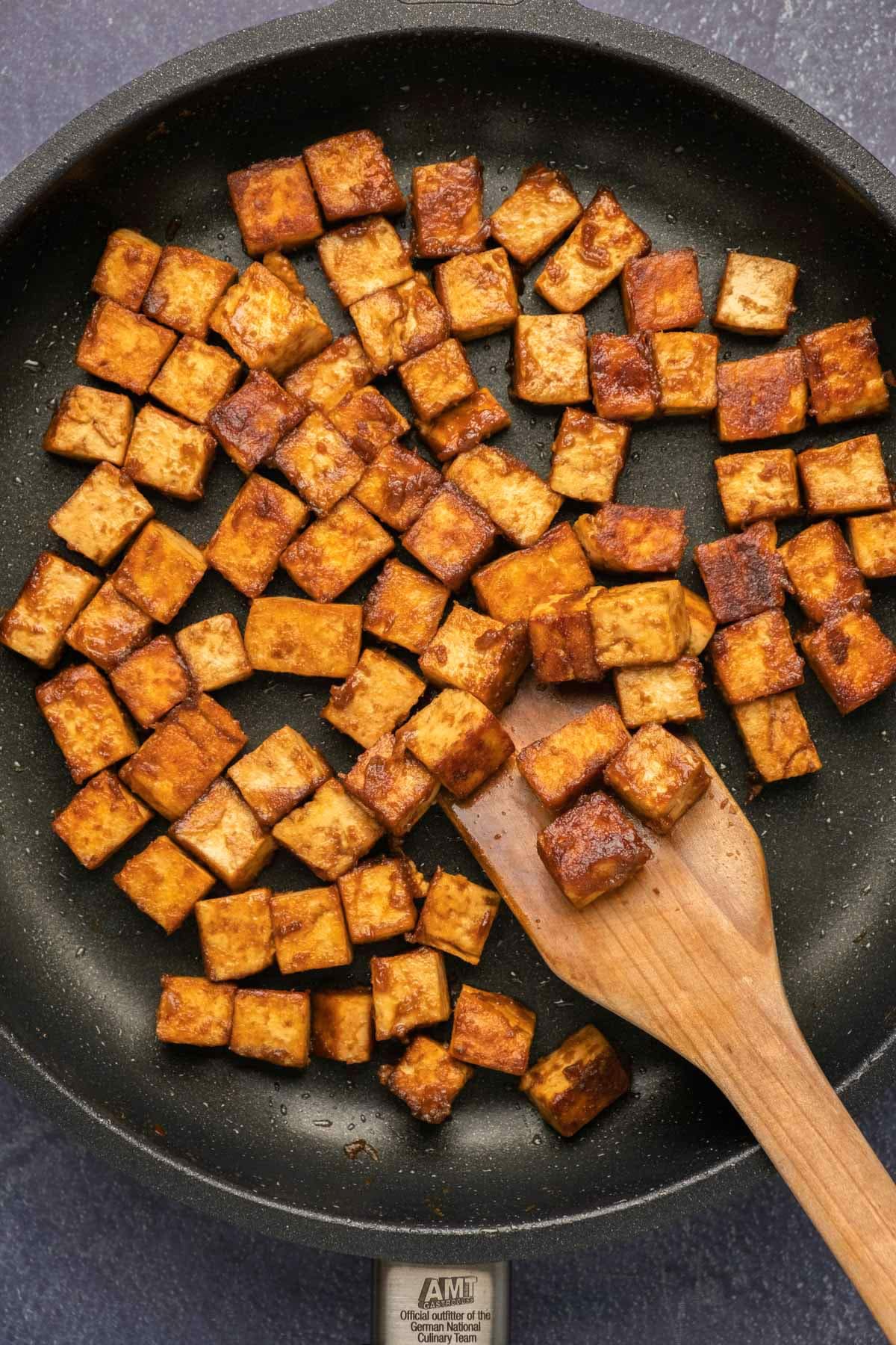 Marinated tofu in a frying pan.