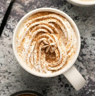 Vegan pumpkin spice latte in a white mug.