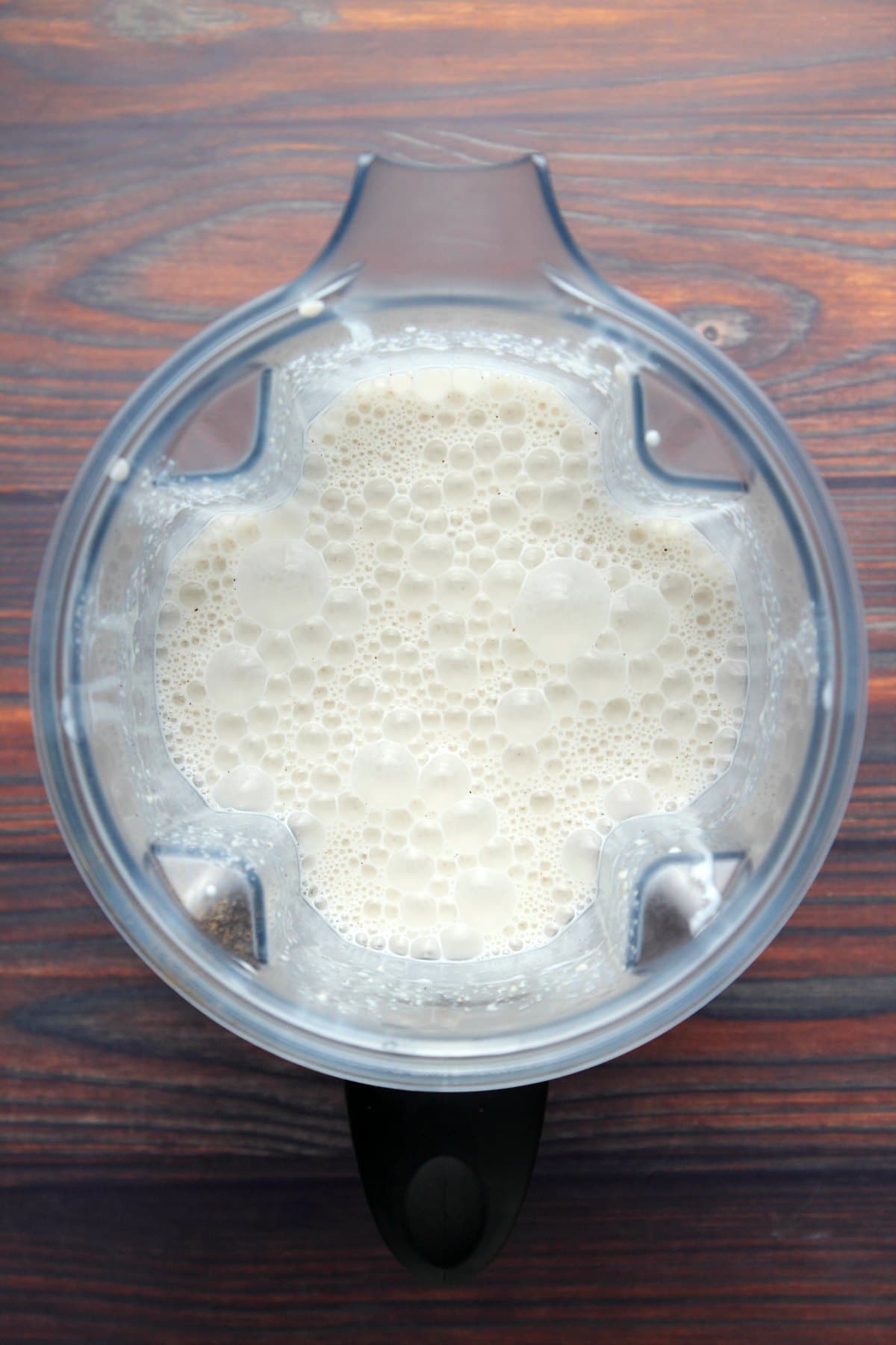 Vegan eggnog mix blended in a blender jug.