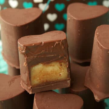 Vegan chocolate caramels with one sliced in half to show the center.