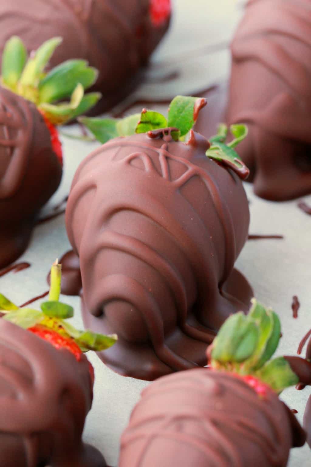  Vegane Erdbeeren mit Schokoladenüberzug auf Pergamentpapier