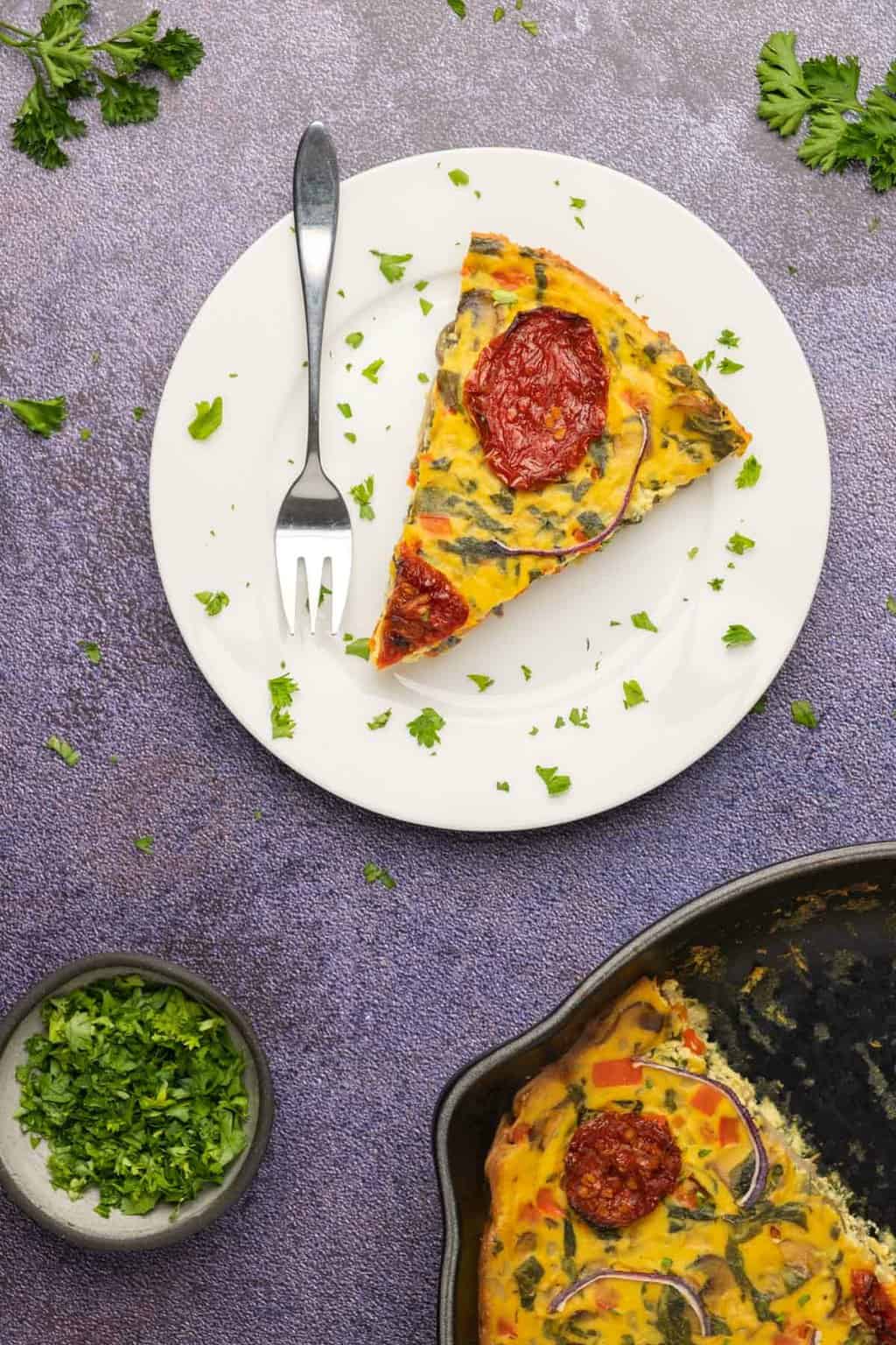 Slice of frittata on a white plate. 
