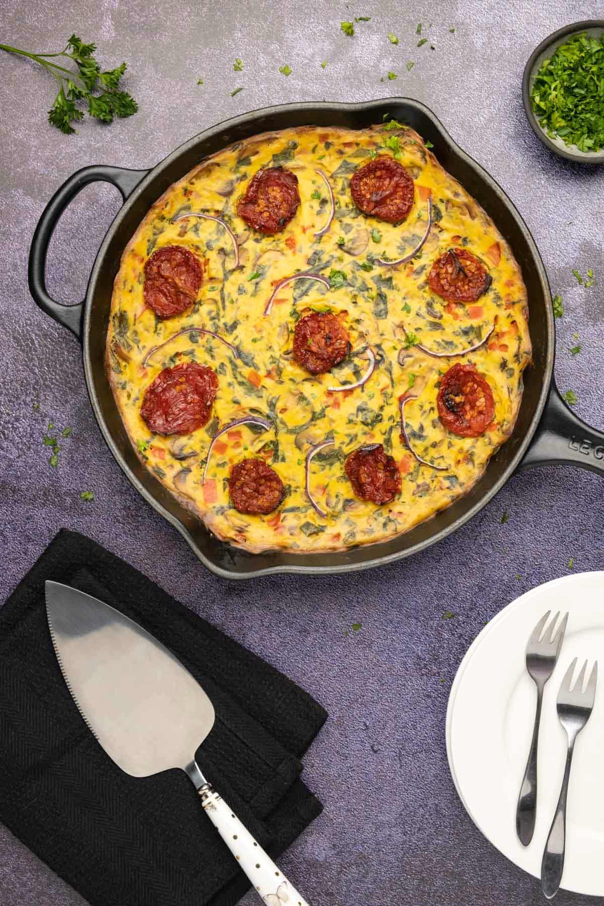 Baked vegan frittata in a cast iron skillet.