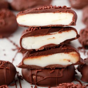 Vegan peppermint patties cut in half and stacked up.