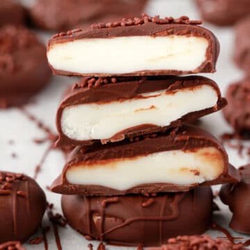 Vegan peppermint patties cut in half and stacked up.