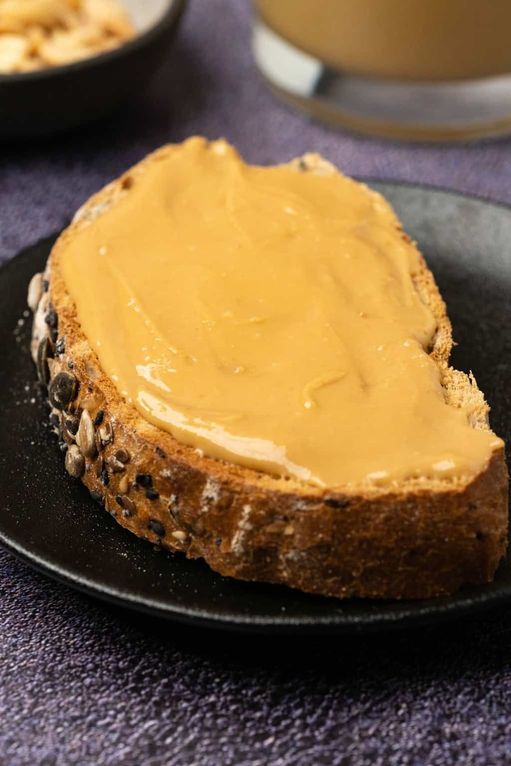 Slice of bread spread with peanut butter. 