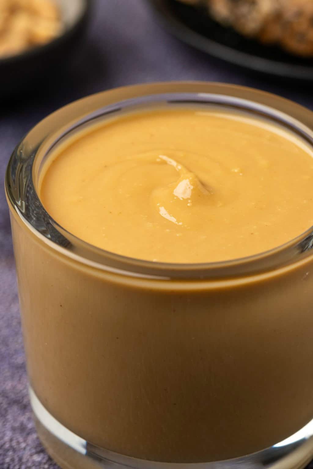 Glass jar filled with peanut butter. 
