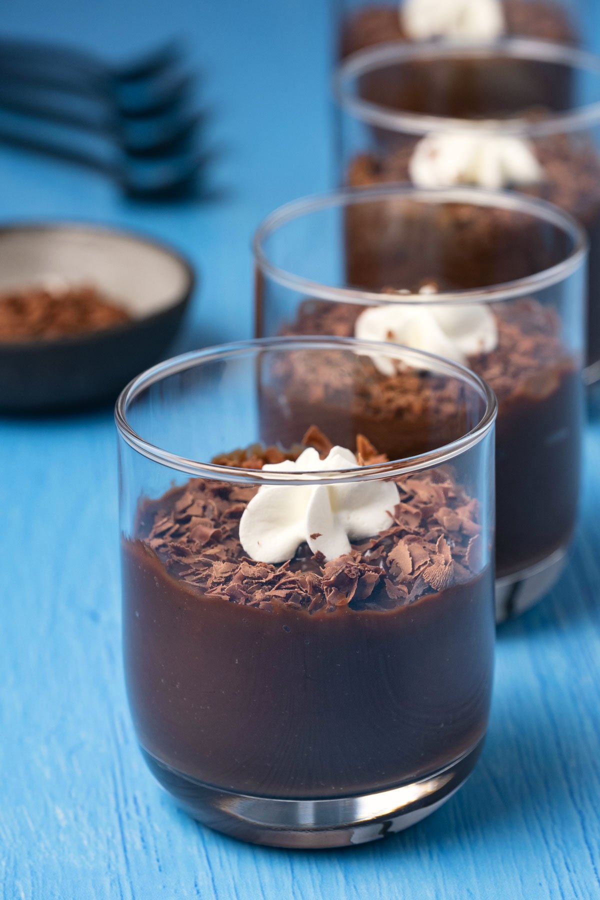 A row of glasses of chocolate pudding. 