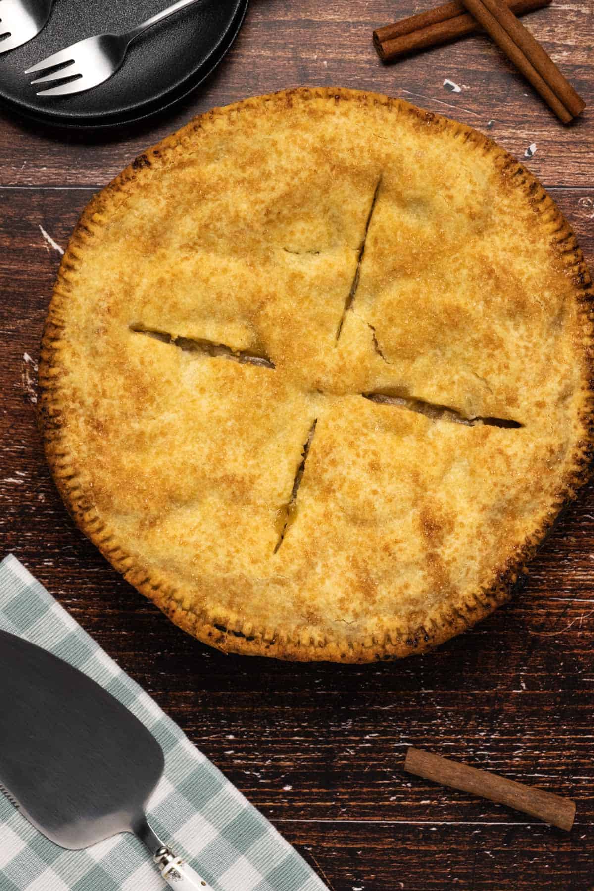 Freshly baked vegan apple pie with slits cut in the top of the crust. 
