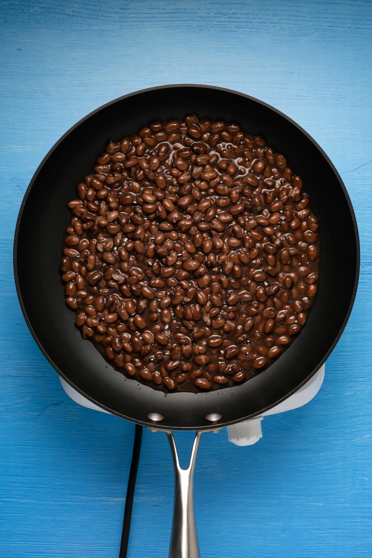Canned black beans in a pan.