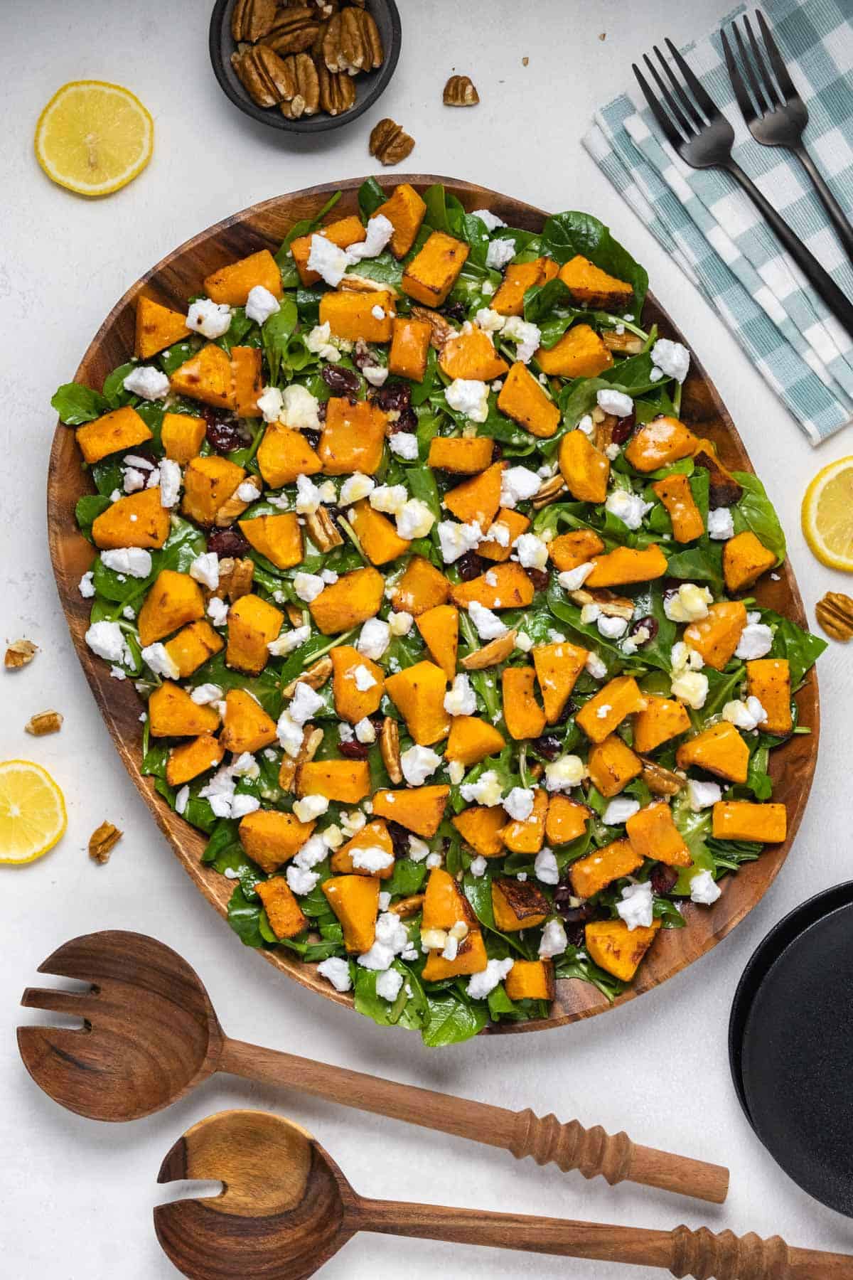 Roasted butternut squash salad in a wooden salad dish. 