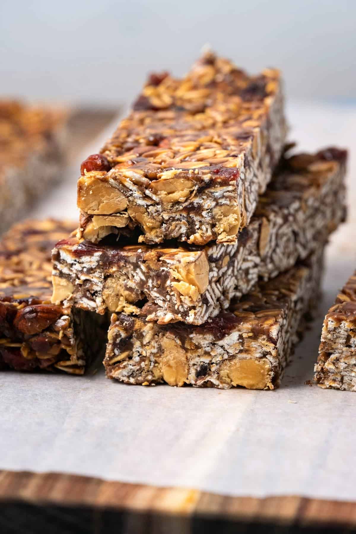 Breakfast bars on a parchment paper lined wooden board. 