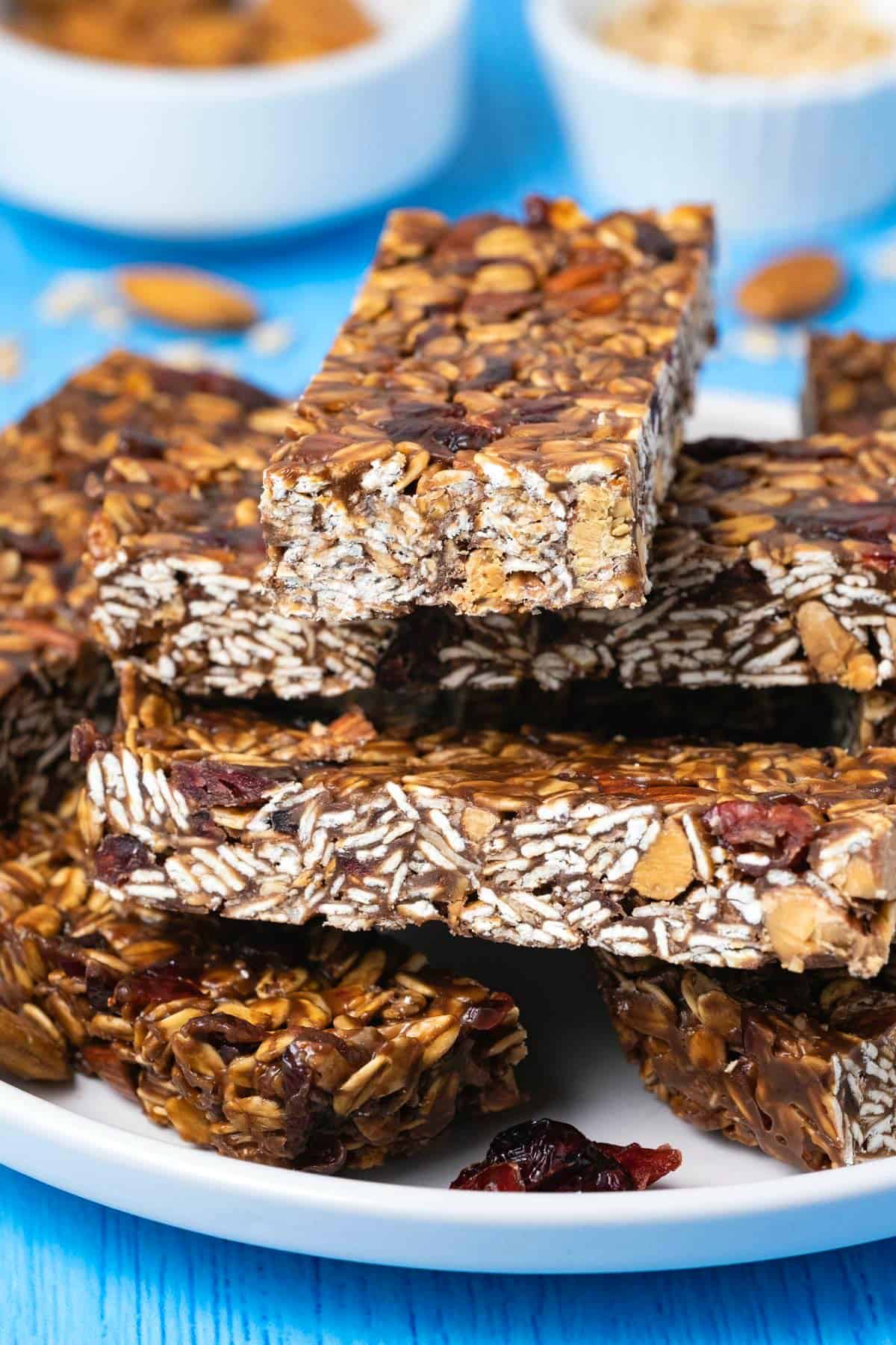 Granola bars stacked up on a white plate. 