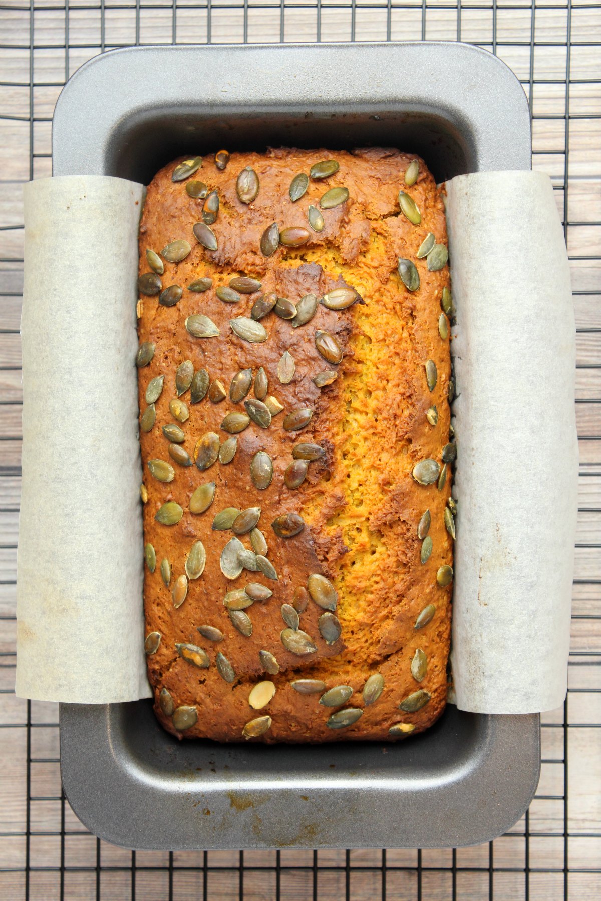 Freshly baked vegan pumpkin bread in a loaf pan.