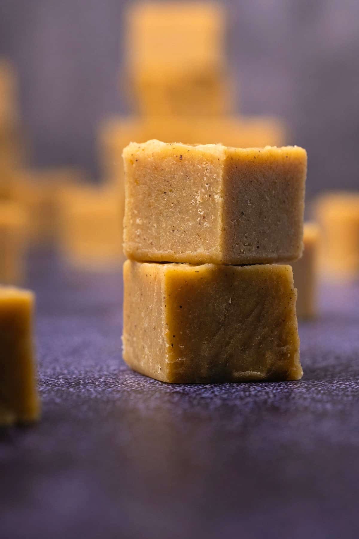 Two blocks of pumpkin fudge stacked on top of each other. 