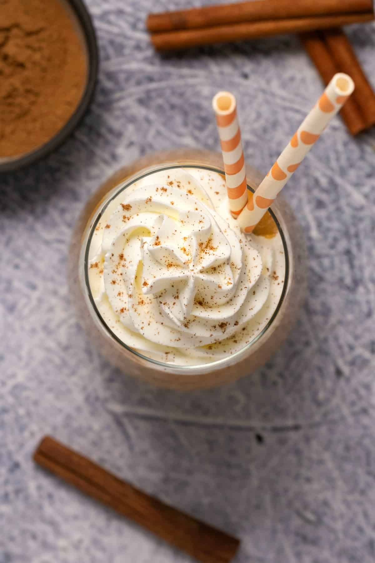 Pumpkin smoothie topped with whipped cream and pumpkin spice. 