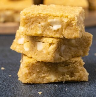 Vegan blondies stacked up in a stack of three.