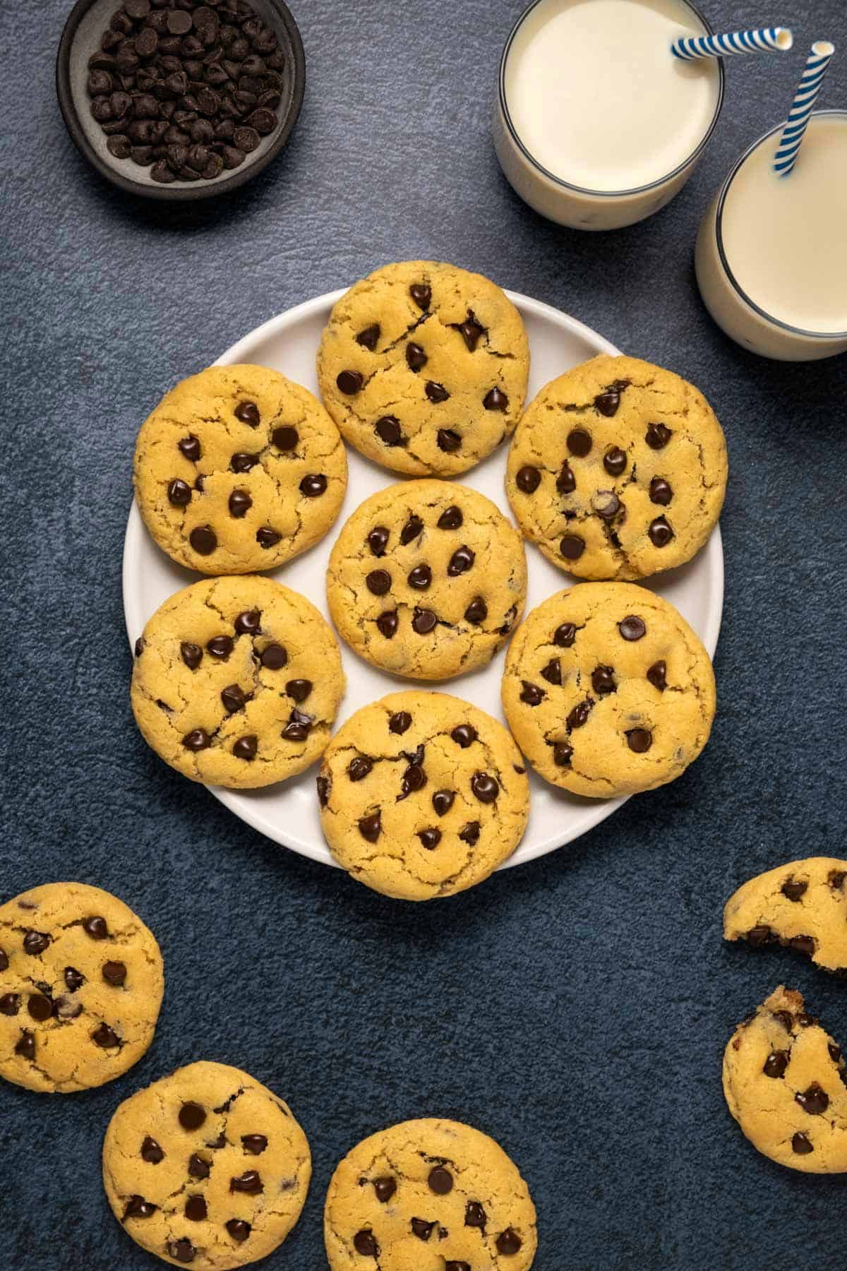 Vegan chocolate chip cookies laid out on a white plate. 