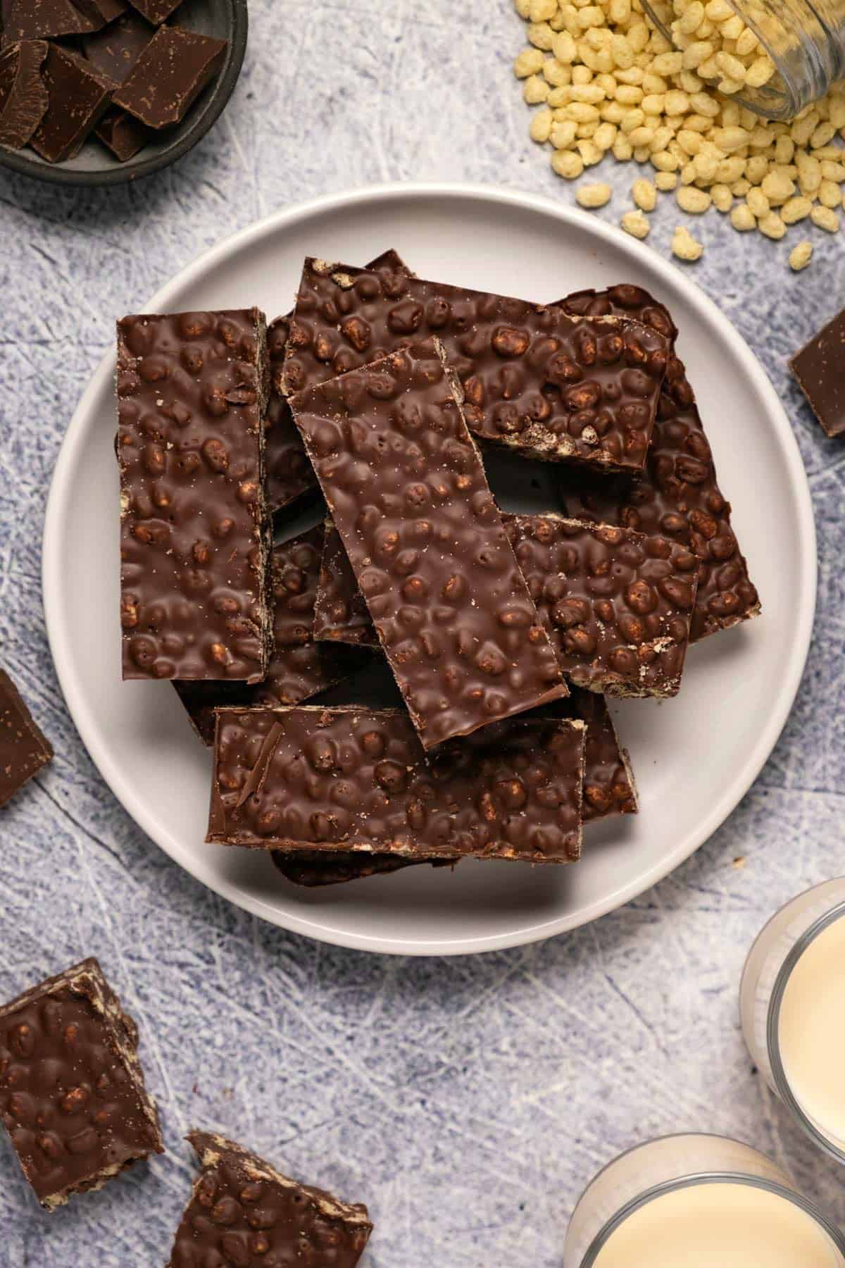 Crunch bars stacked up on a white plate. 