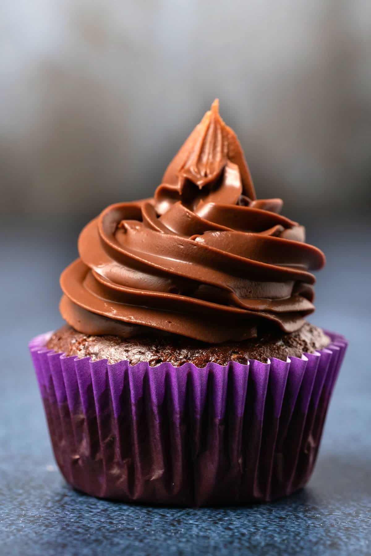 Chocolate cupcake with vegan ganache frosting piped on top. 