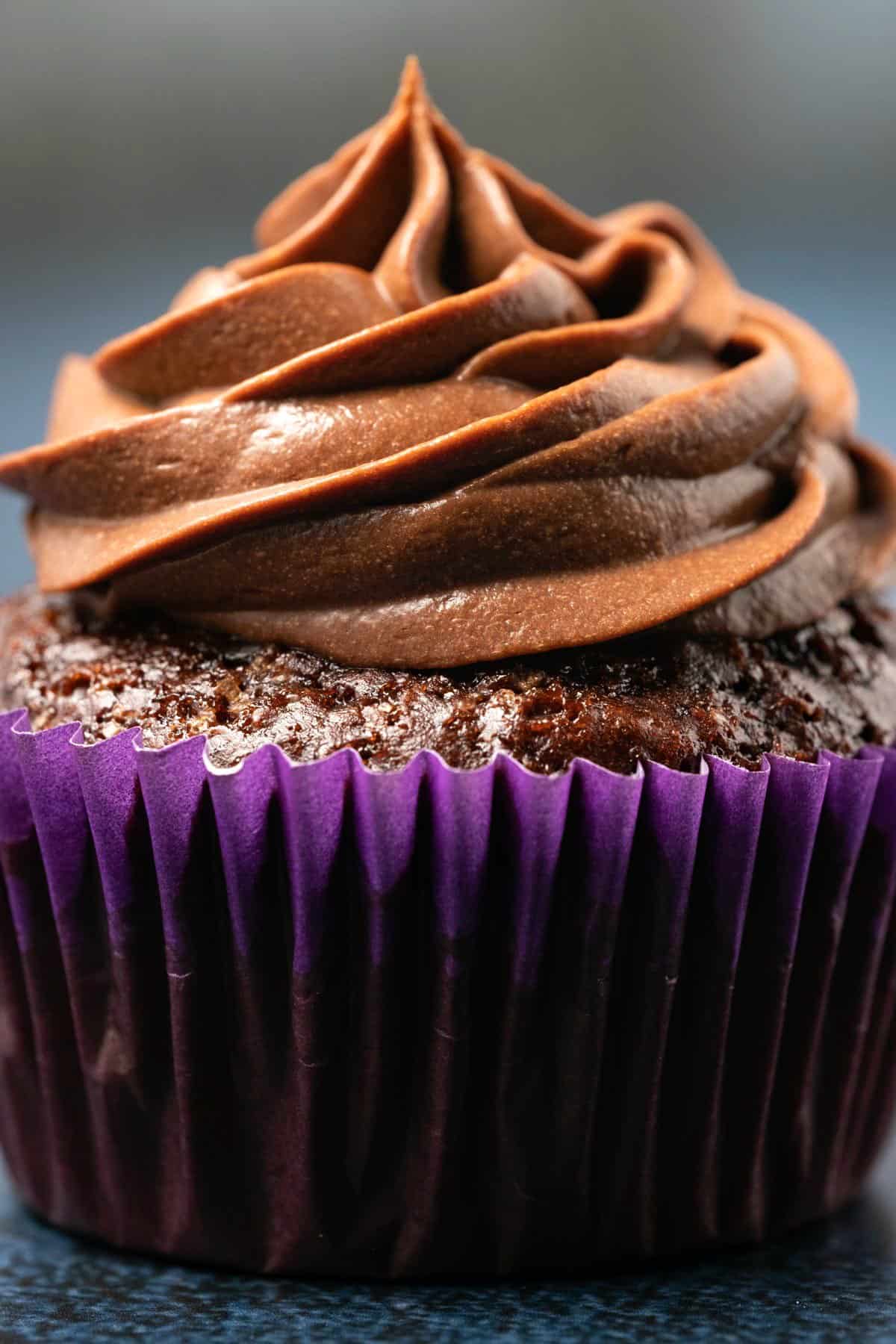 Chocolate cupcake topped with whipped vegan ganache frosting.