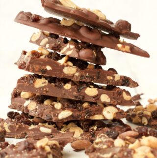 Vegan chocolate bark stacked up on a white plate