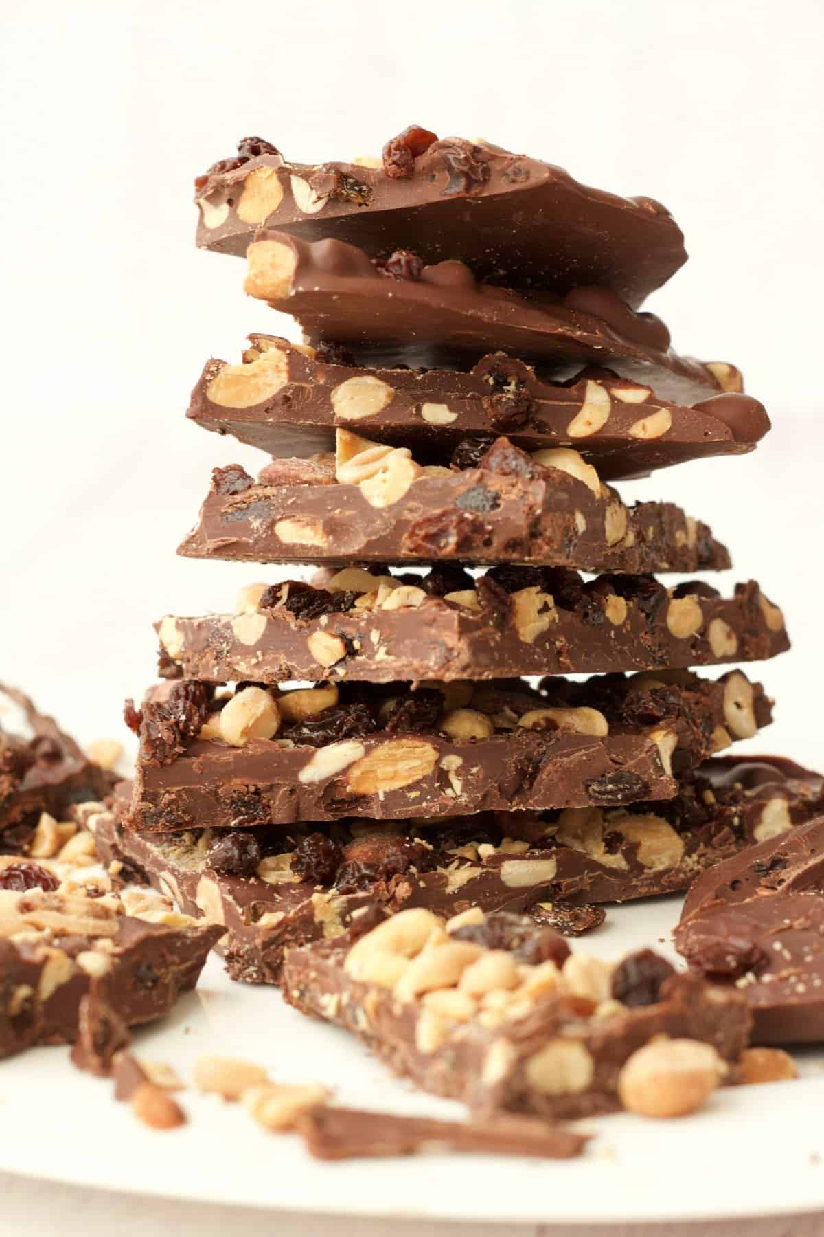 Vegan chocolate bark stacked up on a white plate. 