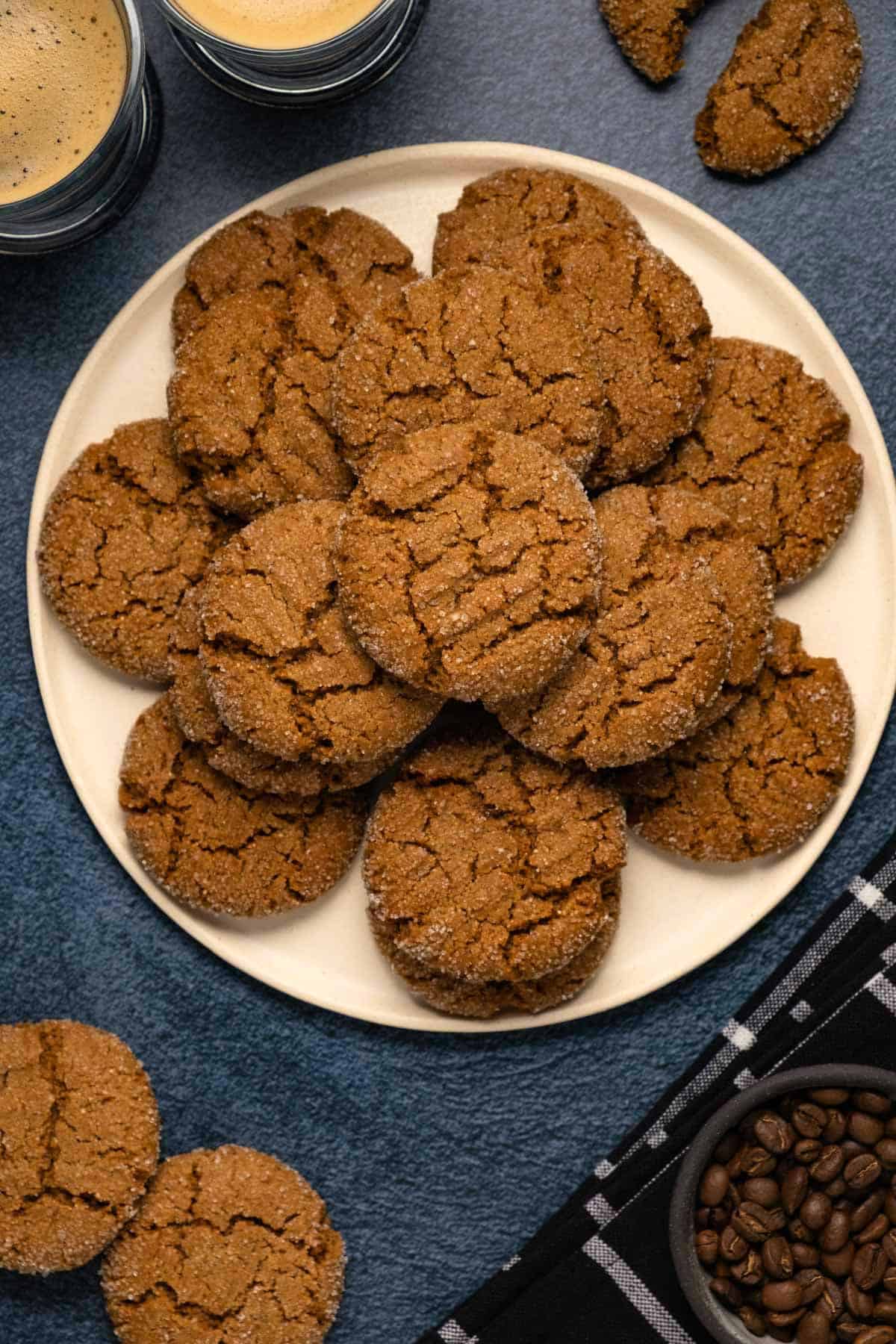 Vegan ginger cookies stacked up on a plate. 