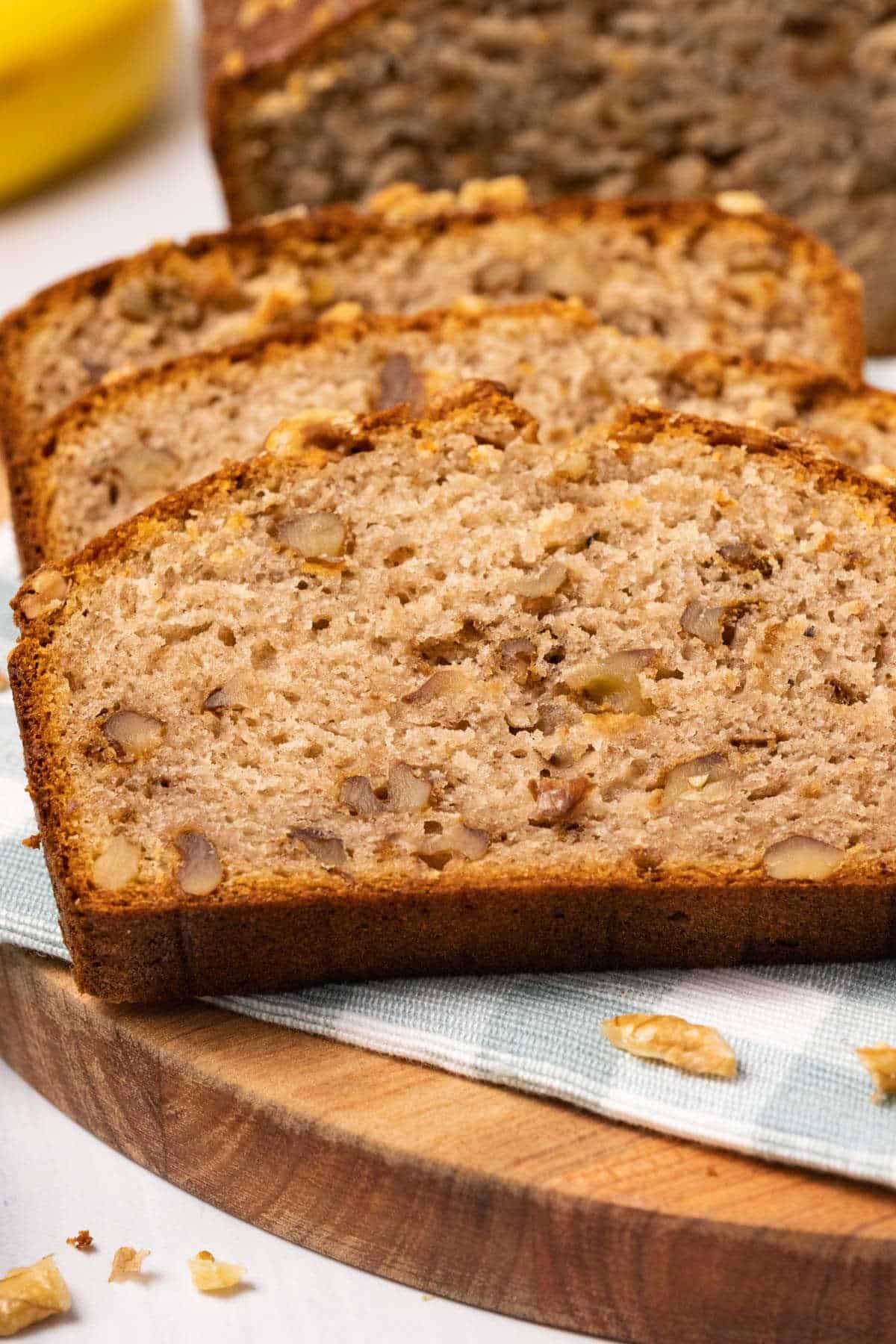 Slices of banana bread on a wooden board. 
