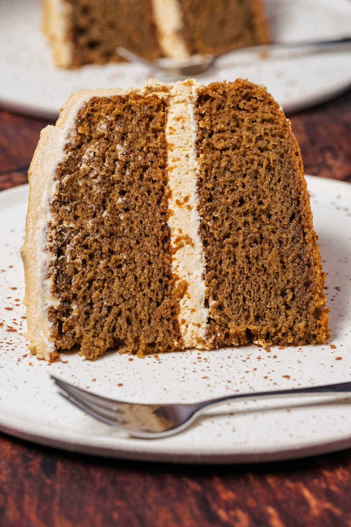 Slice of coffee cake on a white plate with a cake fork.