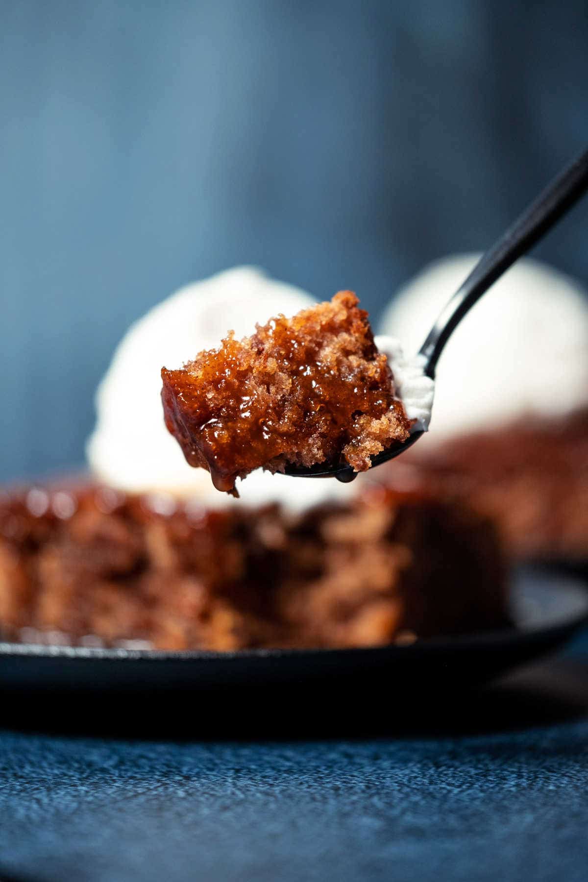 Forkful of vegan sticky toffee pudding.