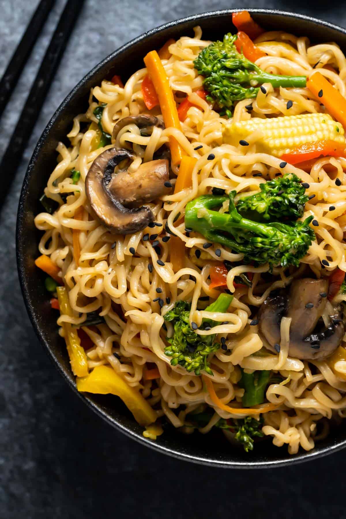 Vegan chow mein in a black bowl.