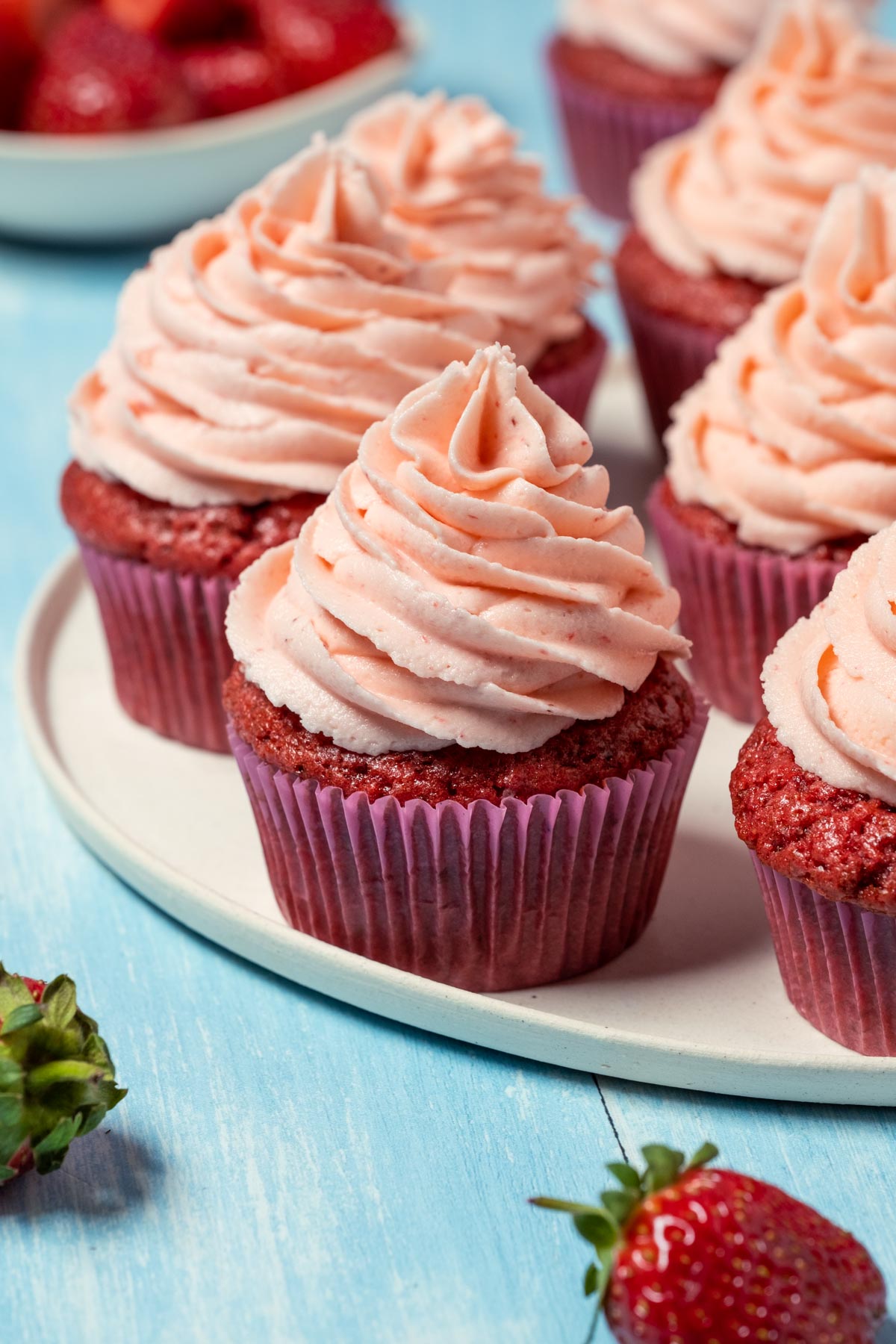 Vegan strawberry cupcakes on a white plate. 