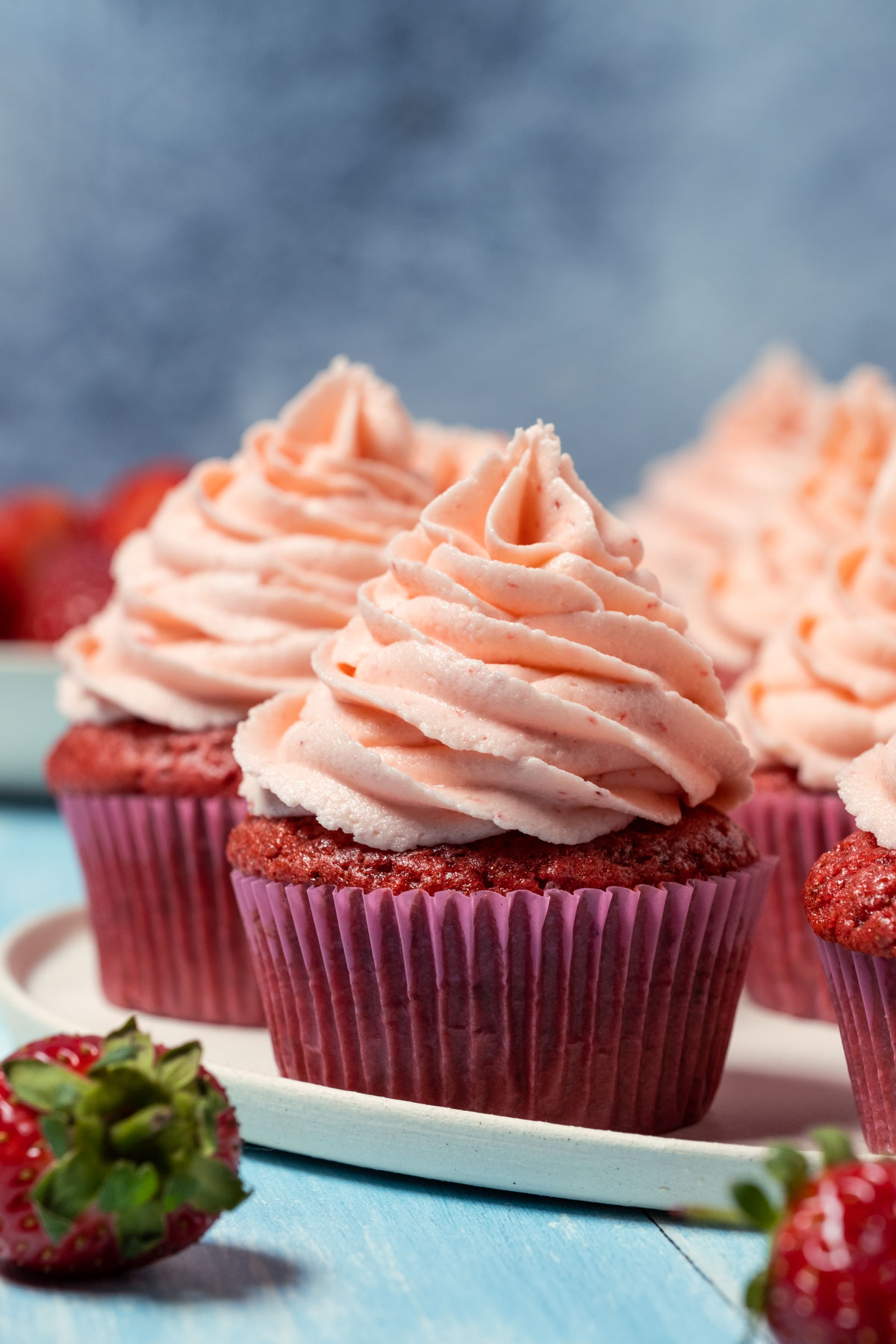 Vegan strawberry cupcakes on a white plate.