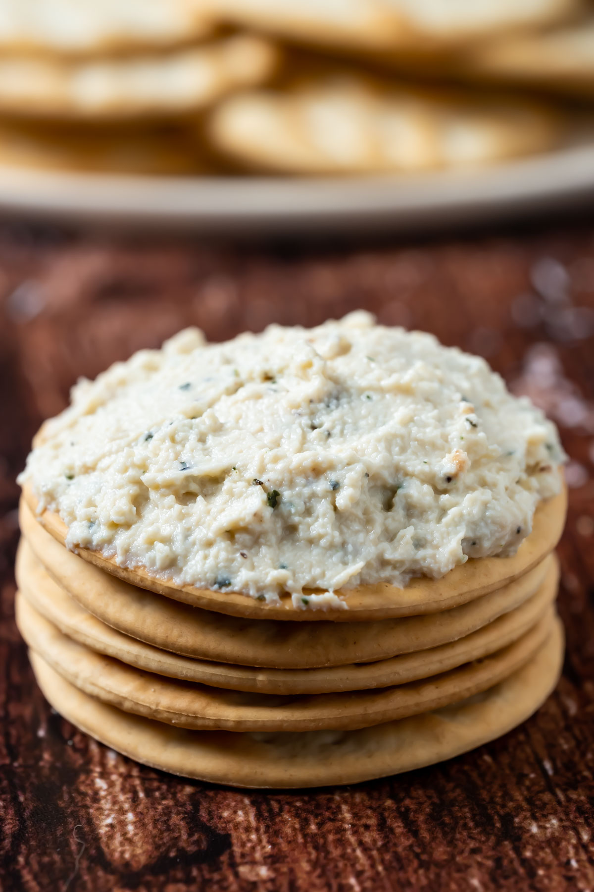 Tofu ricotta spread on a stack of crackers.